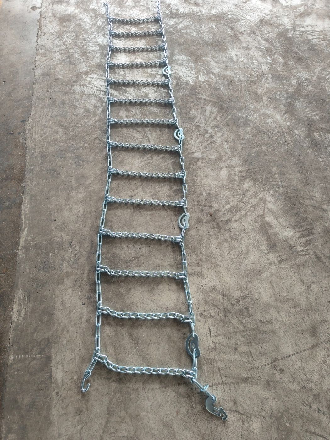 Twist link tire chain laid out on the floor